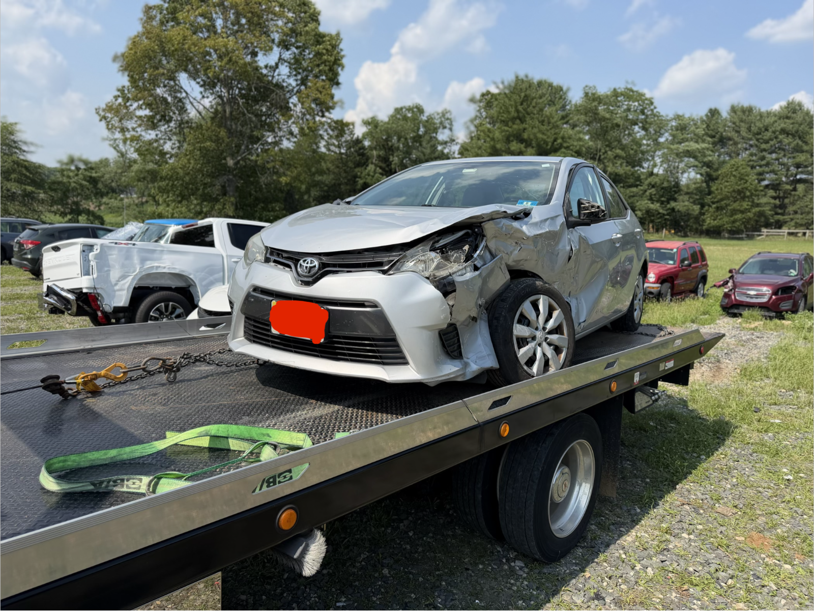 Damaged silver Toyota on Yitz's flatbed